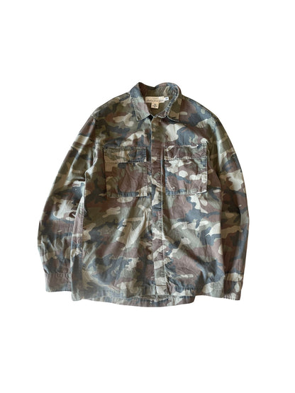 A long-sleeve camouflage button-up shirt jacket with two chest flap pockets, laid flat against a white background.