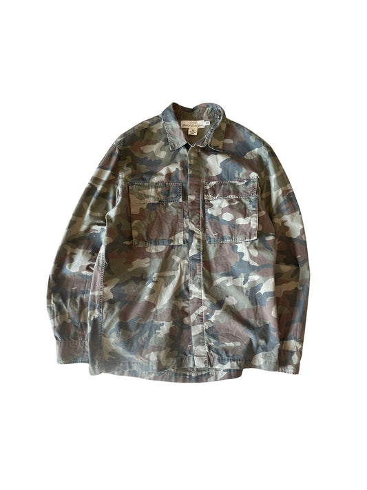 A long-sleeve camouflage button-up shirt jacket with two chest flap pockets, laid flat against a white background.